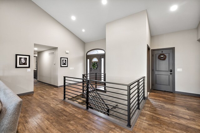 interior space with dark hardwood / wood-style floors and high vaulted ceiling