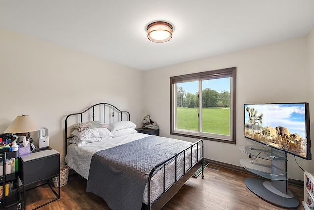 bedroom with dark wood-type flooring