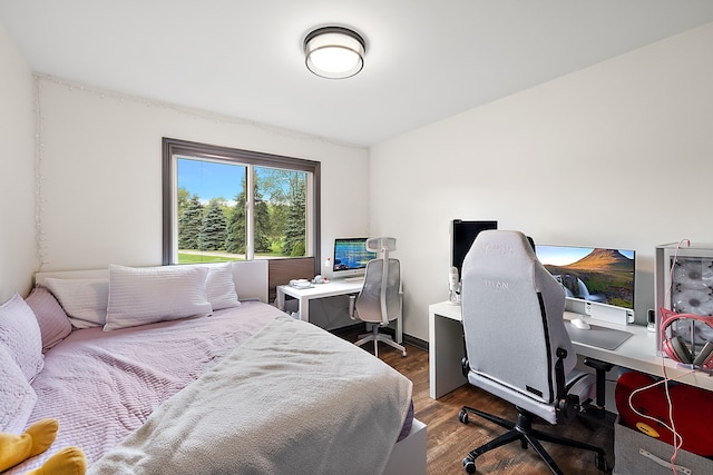 bedroom with dark hardwood / wood-style flooring