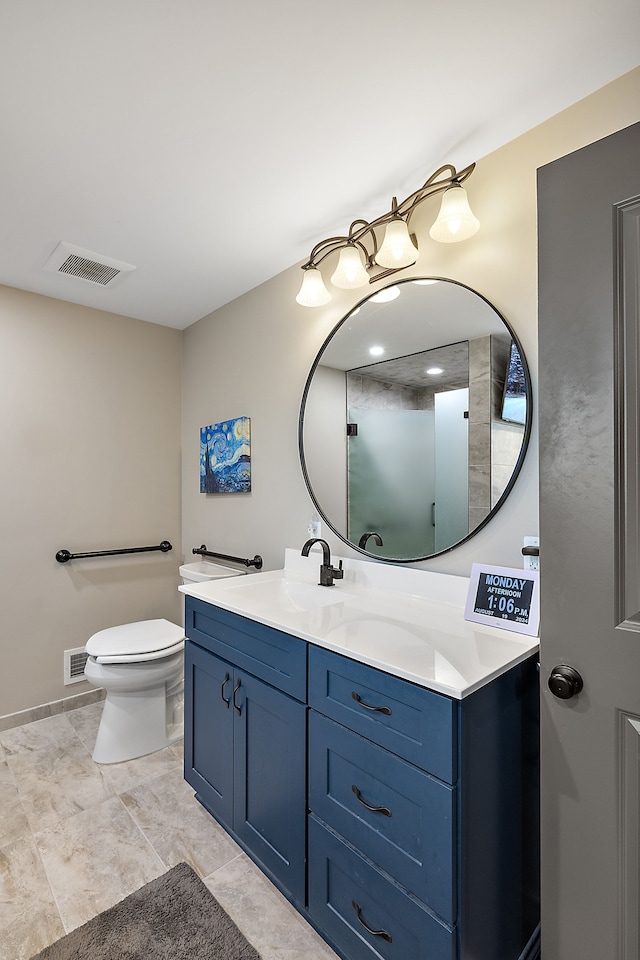 bathroom with tile patterned flooring, vanity, and toilet