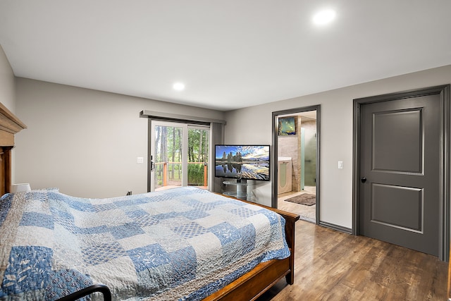 bedroom with ensuite bathroom and hardwood / wood-style floors