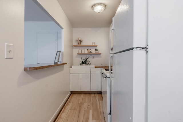 kitchen with open shelves, white cabinetry, light wood-style flooring, baseboards, and white appliances