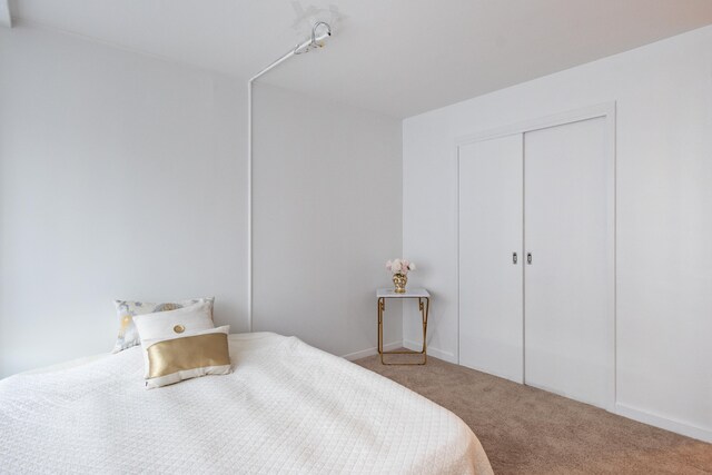 carpeted bedroom with a closet