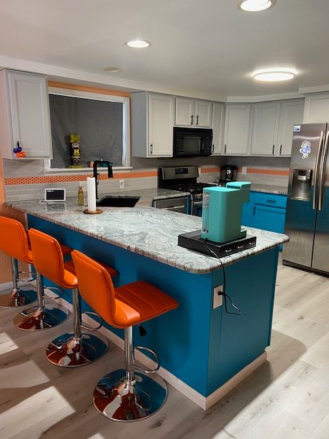 kitchen featuring kitchen peninsula, sink, stainless steel appliances, and light hardwood / wood-style floors