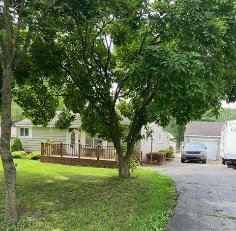 view of yard with a garage and a wooden deck