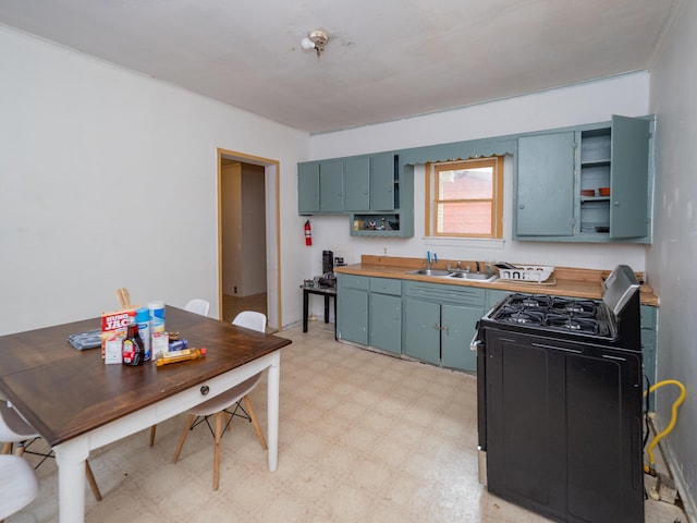 935 Osborne St, Kalamazoo, MI 49001 - kitchen with light flooring, a sink, range with gas stovetop, open shelves, and blue cabinetry