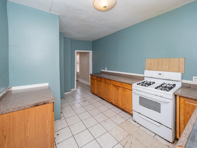 935 Osborne St, Kalamazoo, MI 49001 - kitchen with white gas range and light tile patterned flooring