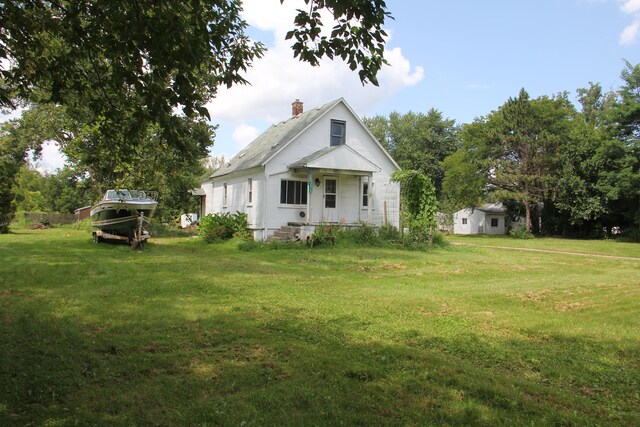 50741 N Ave, Macomb, MI 48042 - rear view of property with a chimney and a yard