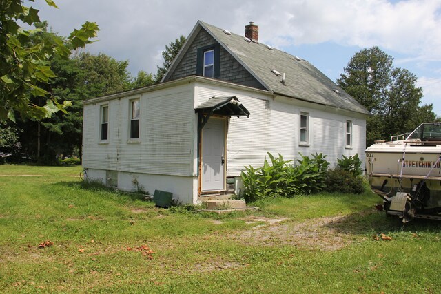 50741 N Ave, Macomb, MI 48042 - view of side of property featuring entry steps, a chimney, and a lawn