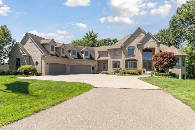 french country home with a front yard and a garage