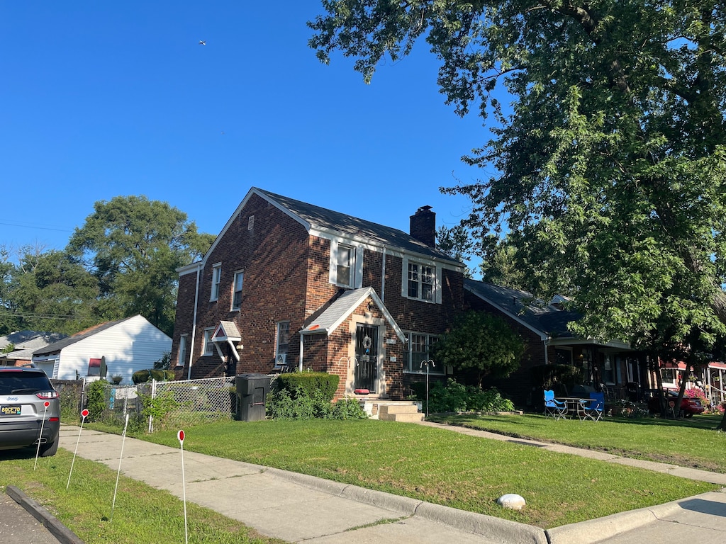 18903 Waltham St, Detroit, MI 48205 - view of front facade with a chimney and brick siding