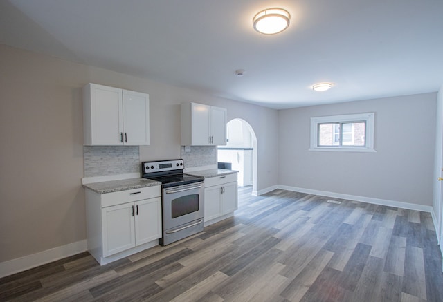 kitchen with white cabinets, tasteful backsplash, dark wood-type flooring, and stainless steel electric range