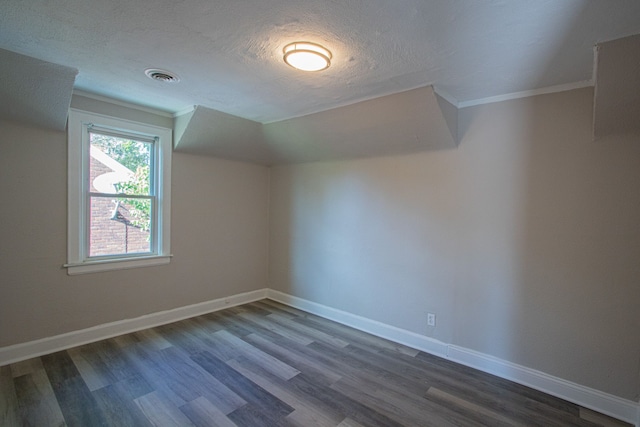 bonus room with a textured ceiling and dark hardwood / wood-style flooring