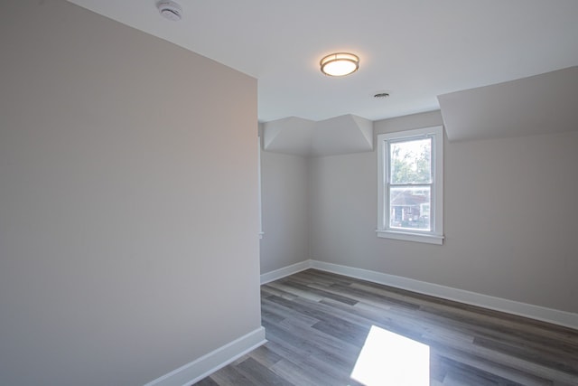 additional living space with dark wood-type flooring