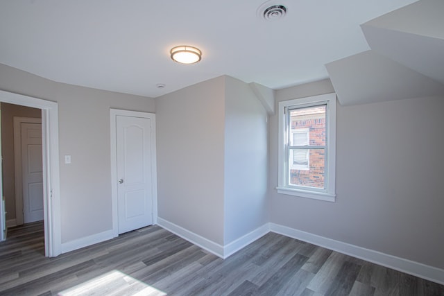 bonus room with dark hardwood / wood-style floors