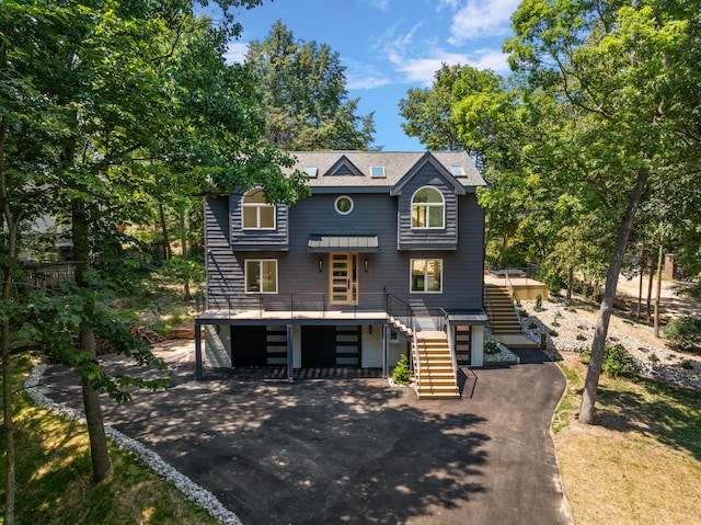 view of front of property with stairs, driveway, and an attached garage