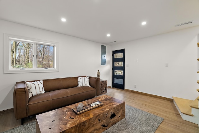 living area with visible vents, baseboards, recessed lighting, and light wood-style floors