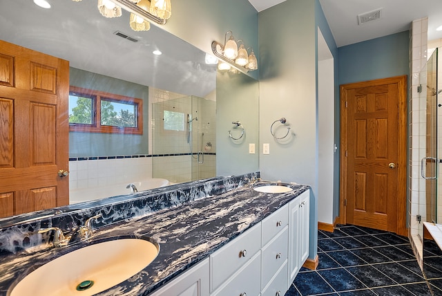 bathroom featuring tile patterned flooring, vanity, and separate shower and tub