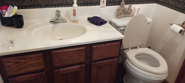 bathroom featuring vanity and toilet