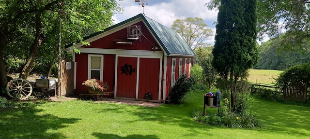 view of outbuilding with a lawn