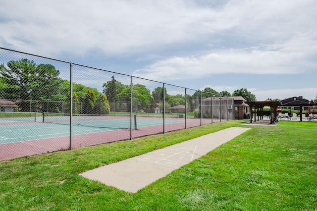 view of sport court featuring a yard