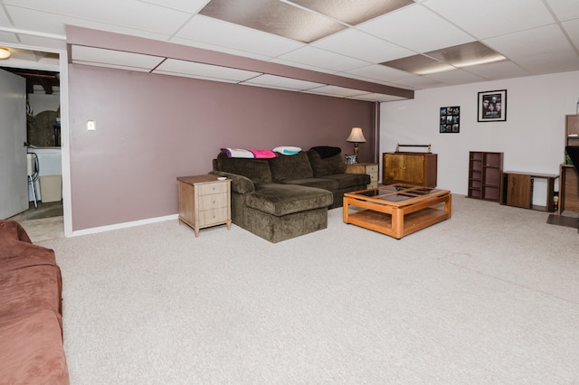 carpeted living room featuring a drop ceiling