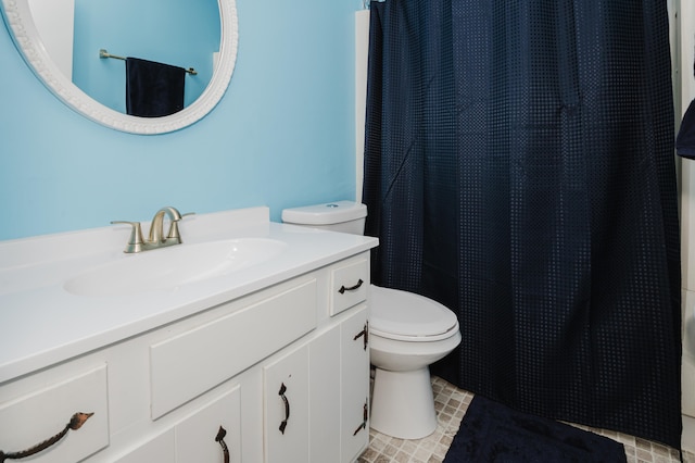 bathroom featuring vanity, a shower with shower curtain, and toilet