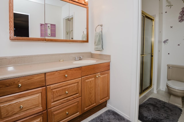 bathroom featuring vanity, toilet, and a shower with door