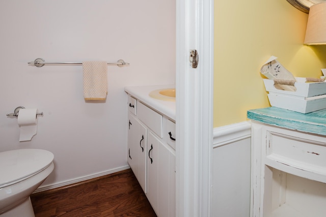 bathroom featuring vanity, wood-type flooring, and toilet