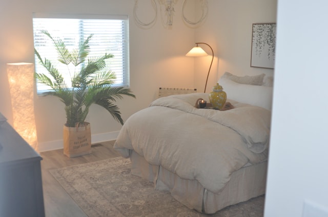 bedroom with hardwood / wood-style floors