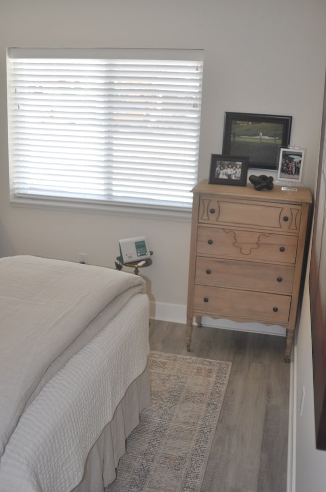 bedroom with dark hardwood / wood-style flooring