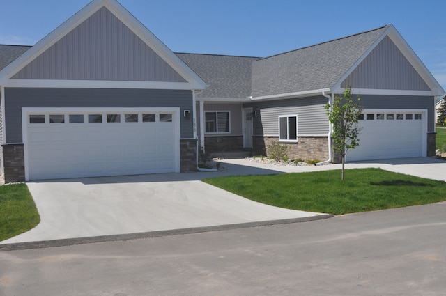 craftsman-style home with a front lawn and a garage