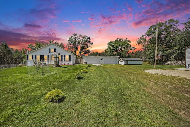 view of front of property with an outbuilding, a garage, and a lawn