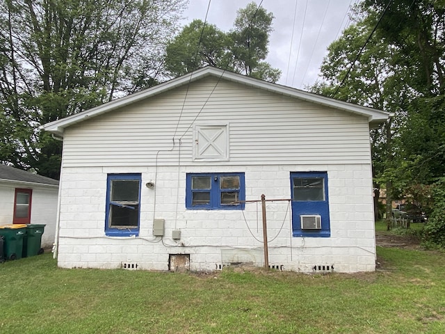 rear view of property with a yard