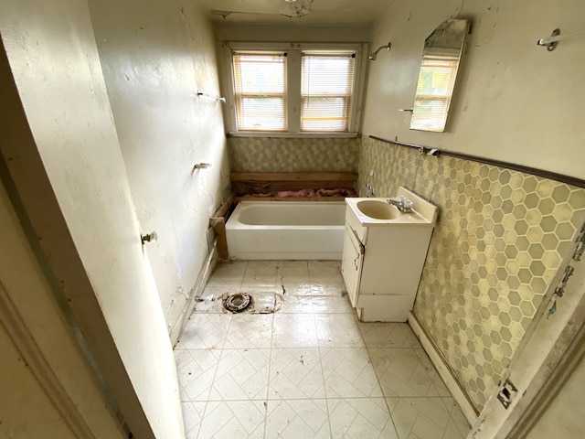 bathroom featuring a bath and vanity