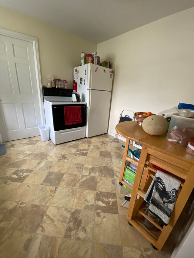 102 Jean St, Yale, MI 48097 - kitchen featuring freestanding refrigerator, electric range, and stone finish floors