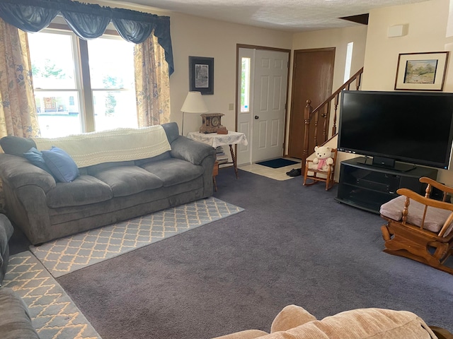 living room featuring a textured ceiling and carpet floors