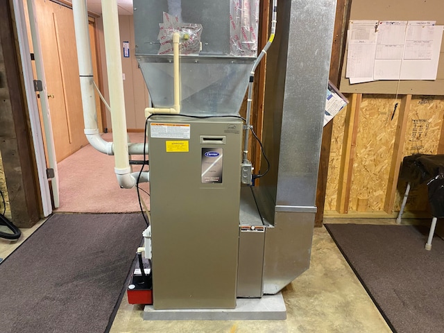 utility room featuring heating unit