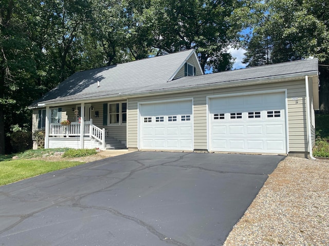 view of front of house featuring covered porch and a garage