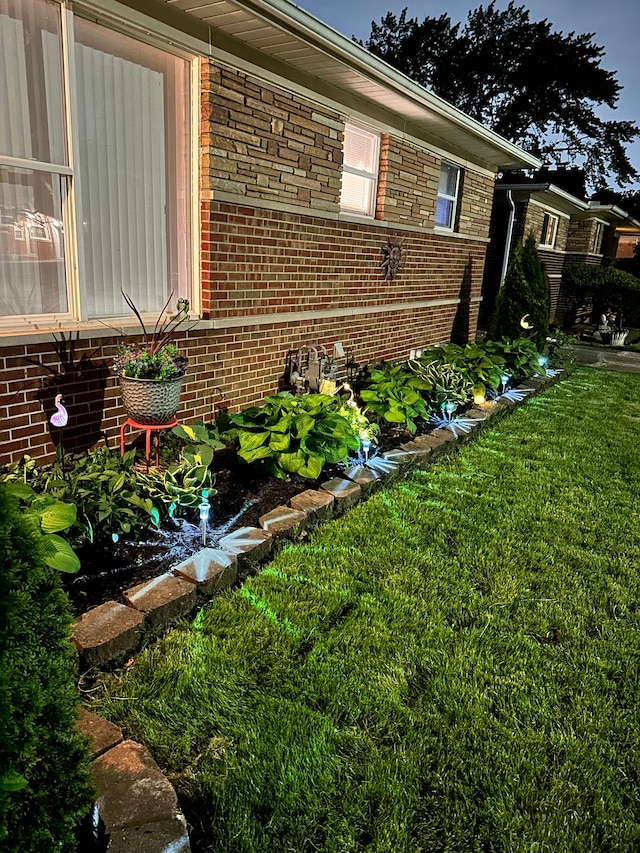 view of side of home with a yard