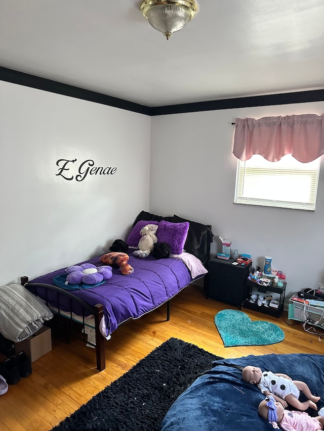 bedroom with hardwood / wood-style flooring