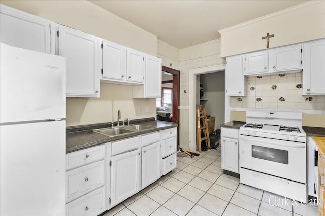 1632 Kalamazoo Ave SE, Grand Rapids, MI 49507 - kitchen featuring white appliances, a sink, dark countertops, white cabinetry, and ornamental molding