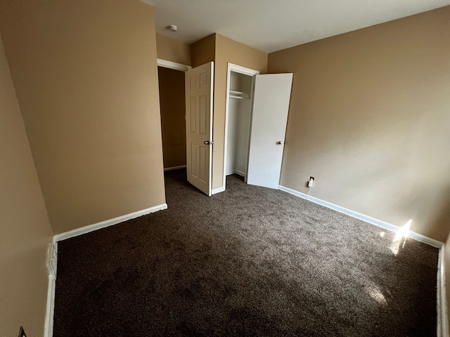 unfurnished bedroom featuring dark colored carpet