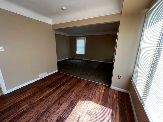 spare room with dark hardwood / wood-style floors