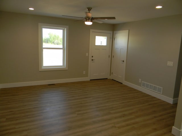 foyer entrance featuring ceiling fan and dark wood-type flooring