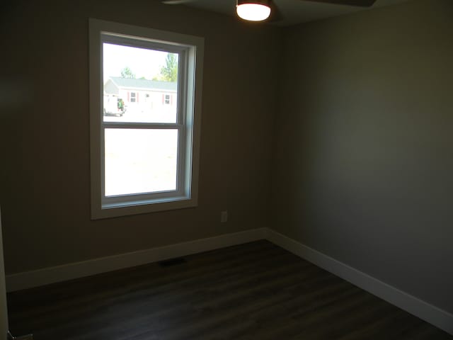 spare room with dark hardwood / wood-style floors