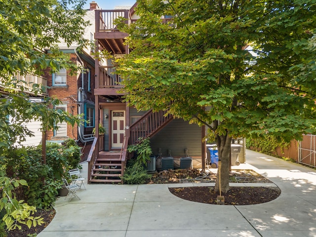 doorway to property featuring a balcony and central AC unit