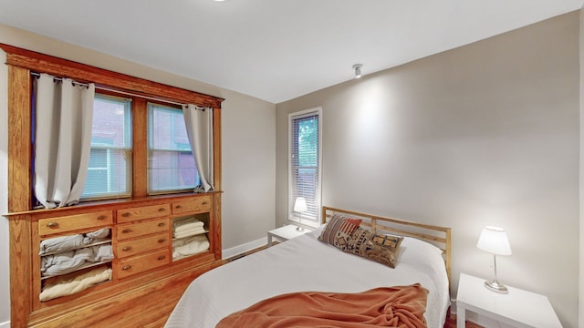 bedroom with hardwood / wood-style flooring