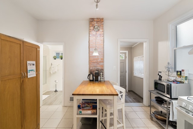 kitchen with butcher block countertops, light hardwood / wood-style floors, white range oven, and ornamental molding