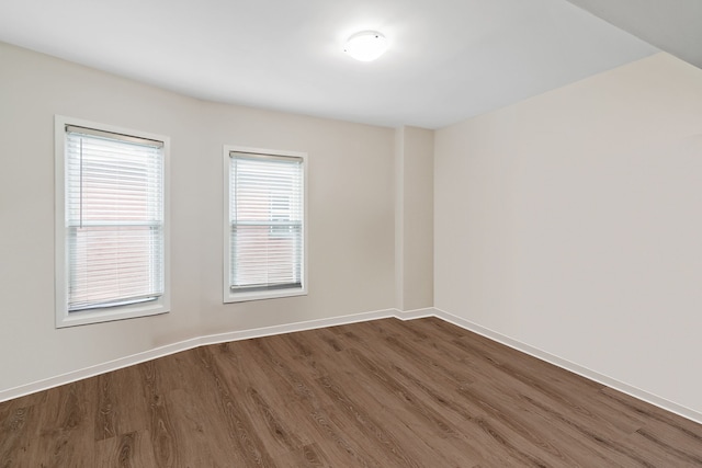 unfurnished room featuring dark hardwood / wood-style flooring